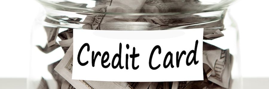 glass jar of money labeled credit card