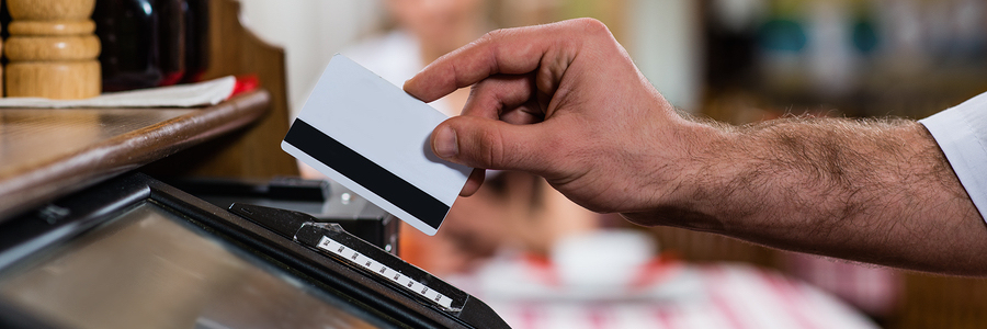 waiter inserts the card into a computer terminal, against visiting the restaurant